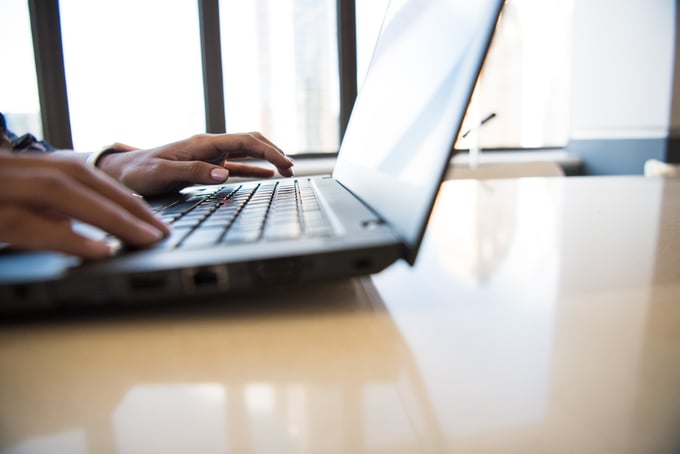 person typing on a laptop 