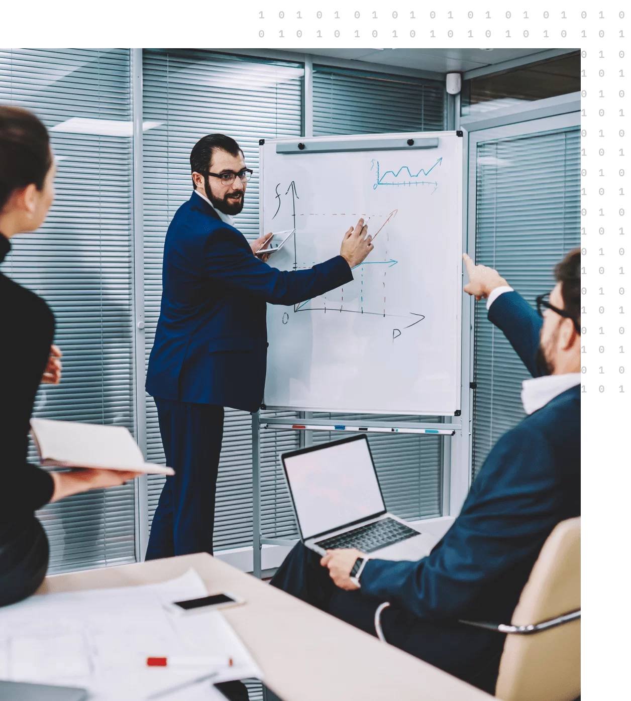 A group of employees outlining a solution on a whiteboard